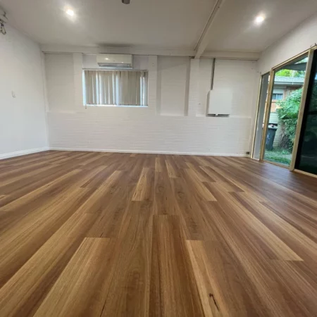 BestBuys QLD Spotted Gum Hybrid flooring - wide view of an unfurnished living room