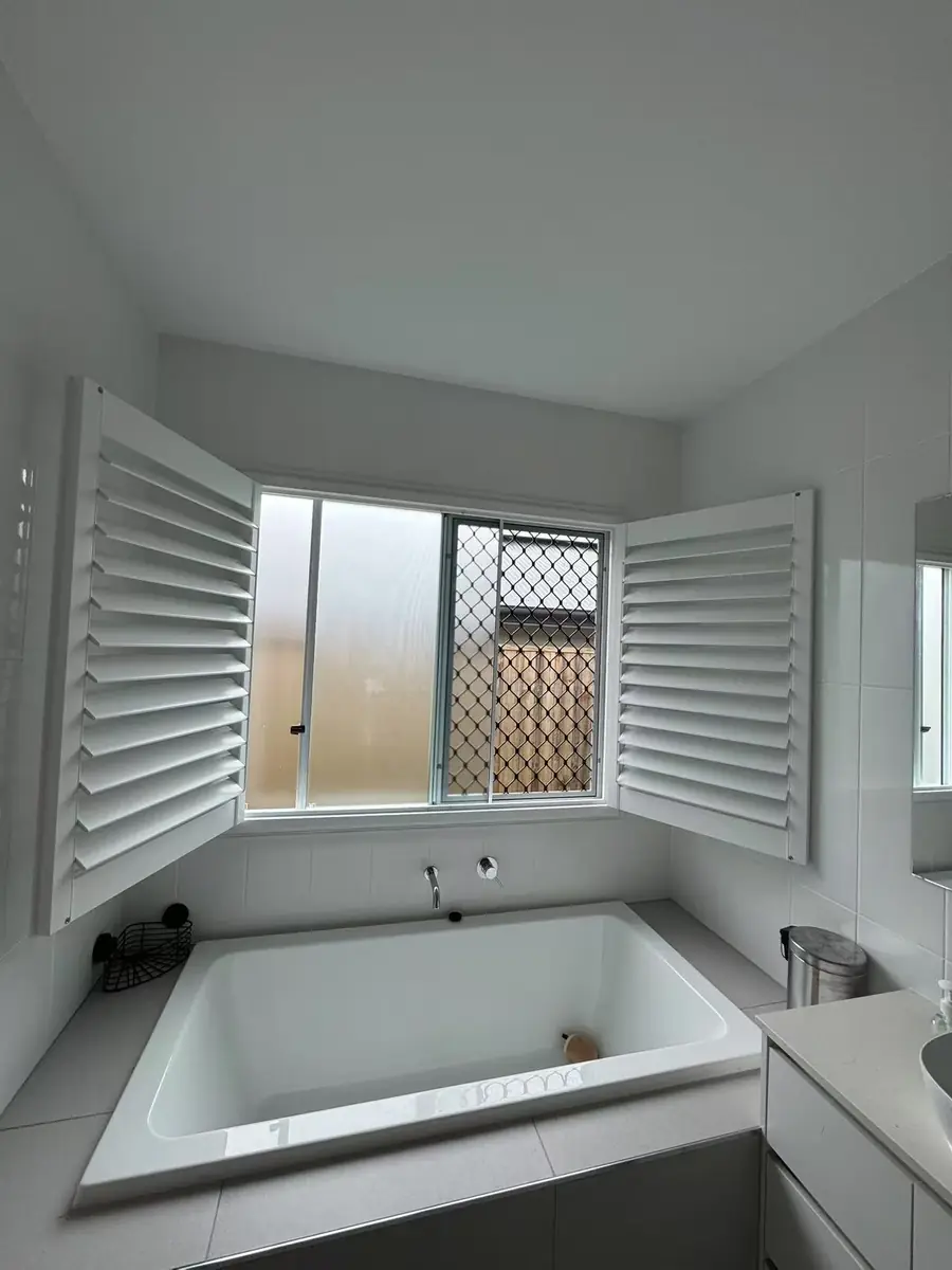 White plantation shutters installed in a Queensland bathroom
