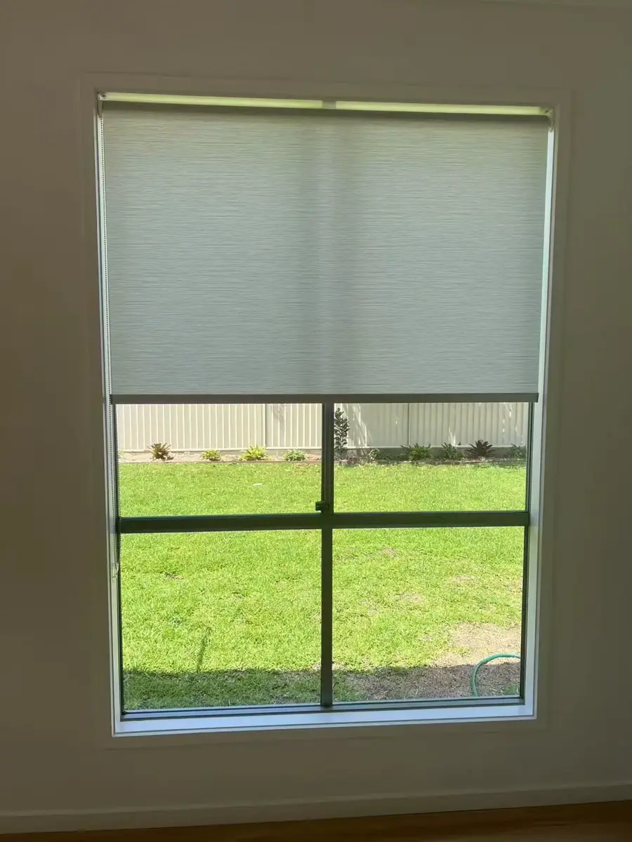 Custom roller blind on a garden-view window in a Brisbane home