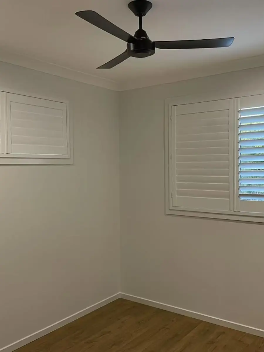 White plantation shutters in a Brisbane bedroom corner