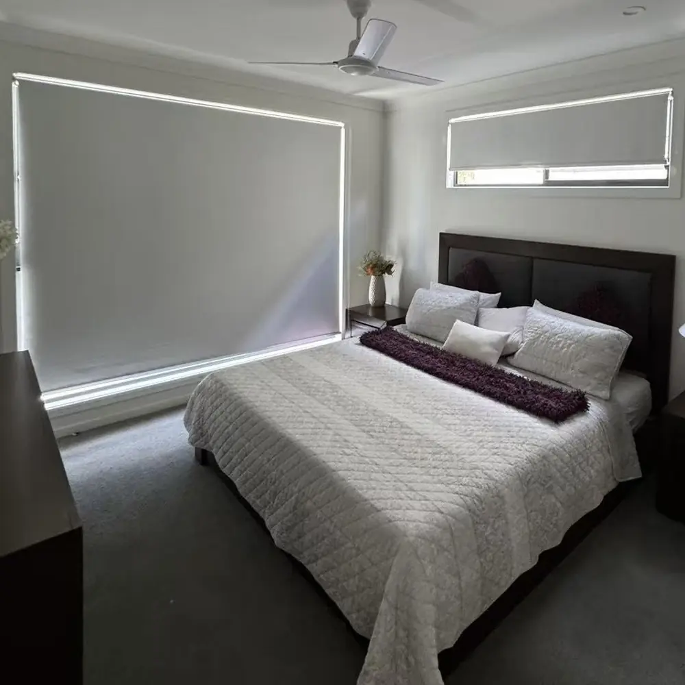 Blockout roller blinds in a styled Brisbane bedroom