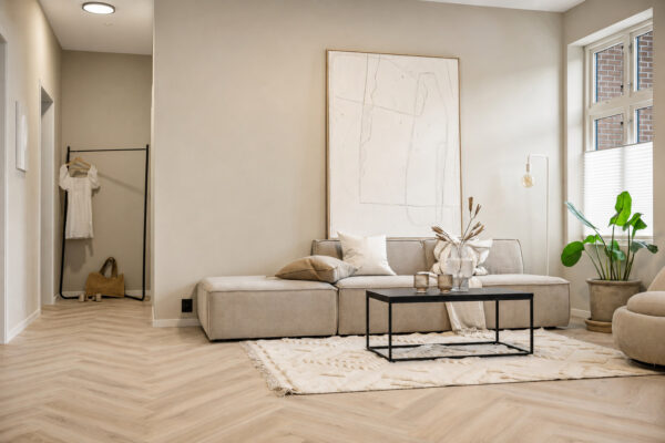 ArtiFloor Premium Herringbone Hamptons Haze vinyl flooring installed in a neutral living room