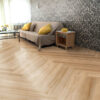 ArtiFloor Premium Herringbone Sandlight vinyl flooring installed in a living room