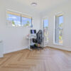 ArtiFloor Premium Herringbone Sandlight vinyl flooring installed in a home office