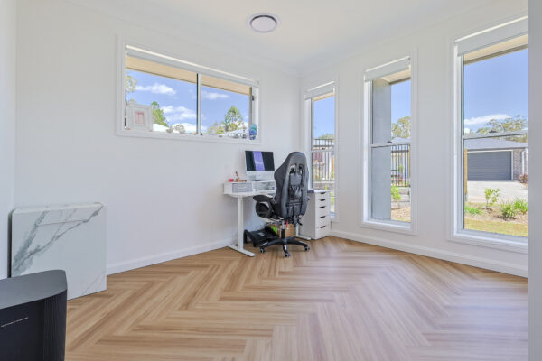 ArtiFloor Premium Herringbone Sandlight vinyl flooring installed in a home office