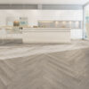 ArtiFloor Premium Herringbone Mistwood vinyl flooring installed in a white kitchen