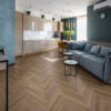 ArtiFloor Premium Herringbone Rustic Path vinyl flooring installed in an open-plan living room