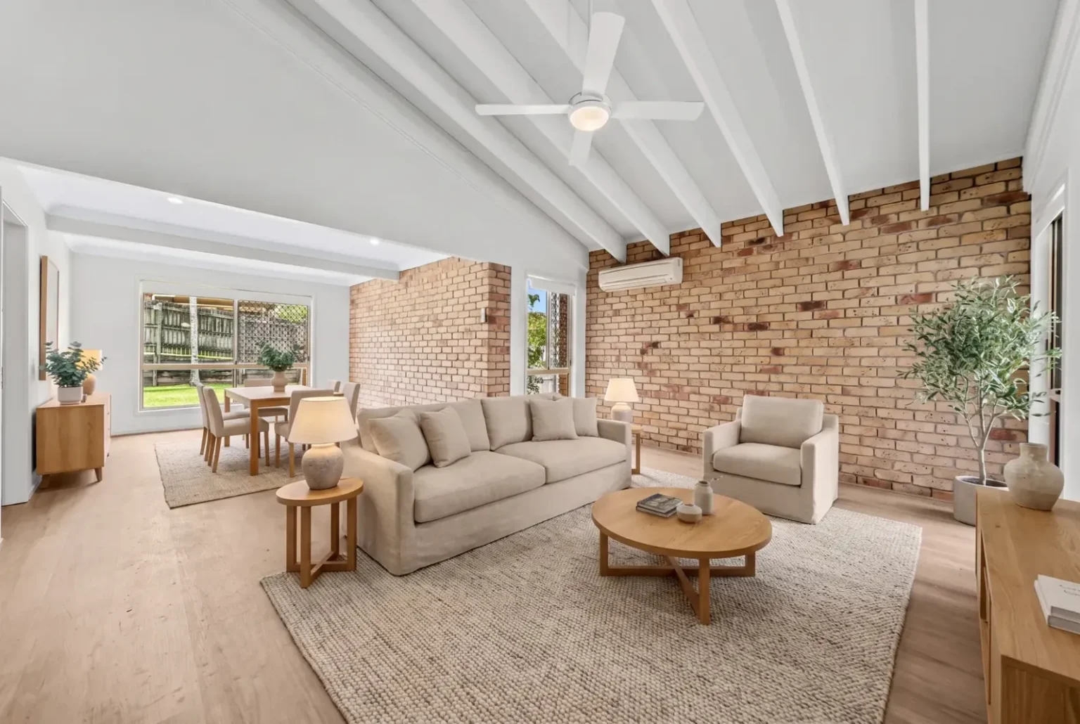 Styled living room with exposed brick wall and BestBuys Neutral Oak hybrid flooring
