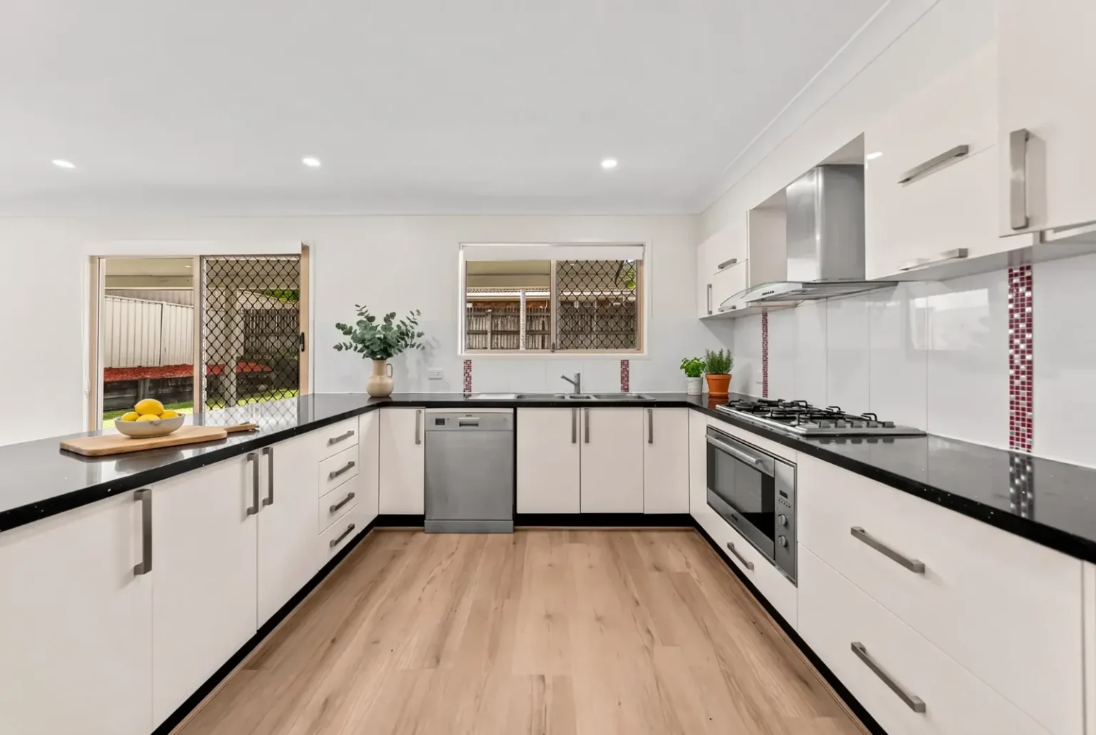 White U-shaped kitchen with BestBuys Neutral Oak hybrid flooring