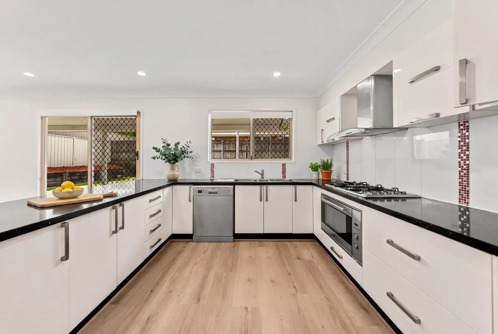 White U-shaped kitchen with BestBuys Neutral Oak hybrid flooring
