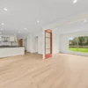 Unfurnished open-plan living area showing BestBuys Neutral Oak hybrid flooring planks