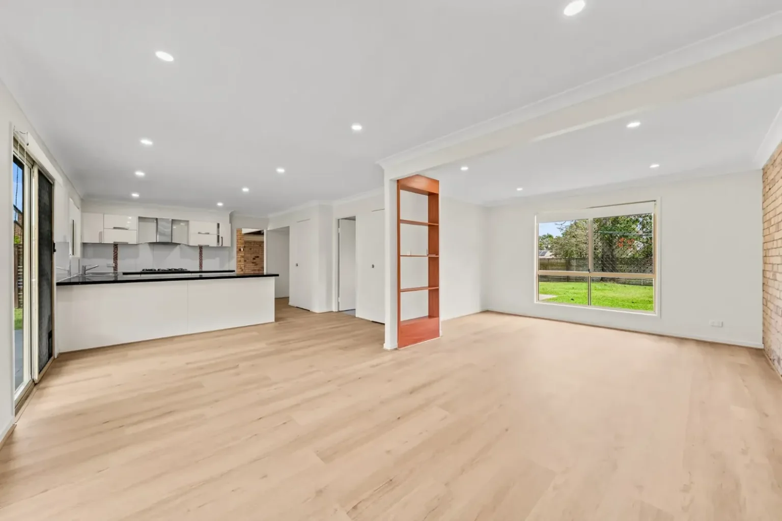 Unfurnished open-plan living area showing BestBuys Neutral Oak hybrid flooring planks